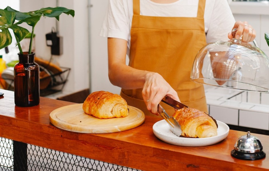 Person serving pastry on plate